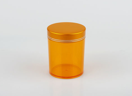 Flacon transparent en plastique orange avec écrou en aluminium